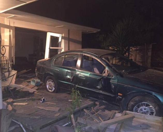 The car that crashed through the house, injuring the dog. Photo: New Zealand Police