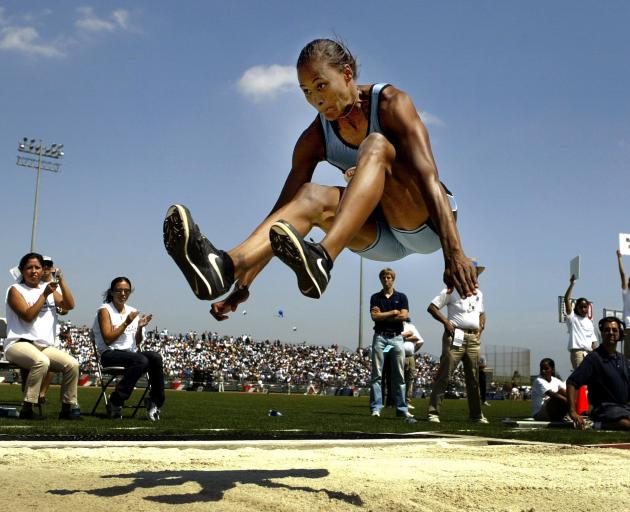 American  Marion Jones leaps 7.13m to win the long jump at the track and field invitational in...