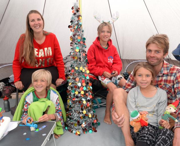 Celebrating Christmas Day in their tent at Dunedin Holiday Park are (clockwise from front left)...