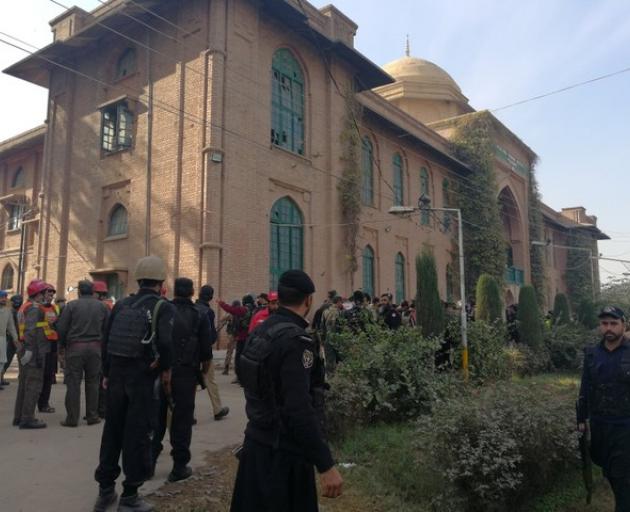 Police and rescue workers stand outside the Directorate of Agriculture Institute in Peshawar. Photo: Reuters