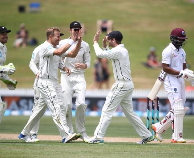 Neil Wagner celebrates taking a wicket with his Black Caps team mates against the West Indies in...