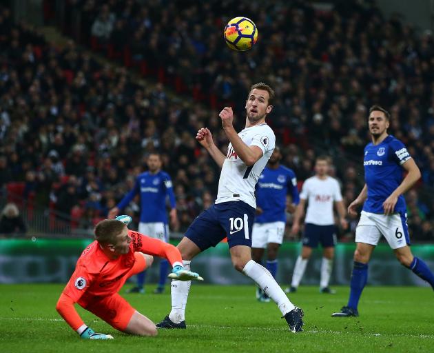 A familiar sight: Tottenham Hotspurs' Harry Kane guides the ball past Everton's Jordan Pickford...