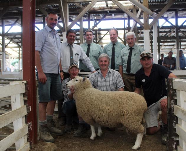 Surrounding the top-priced ram at this week’s Gore ram fair are (from left, back) buyers Matt...