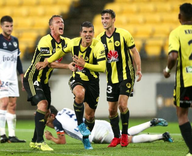 Andrija Kaludjerovic, Goran Paracki and Matthew Ridenton celebrate an own goal by Mark Milligan...