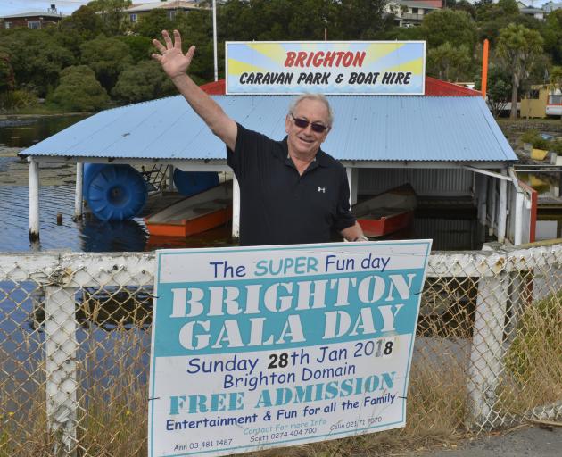 Colin Weatherall hangs up signs ahead of the Brighton Gala Day. Photo: Gerard O'Brien