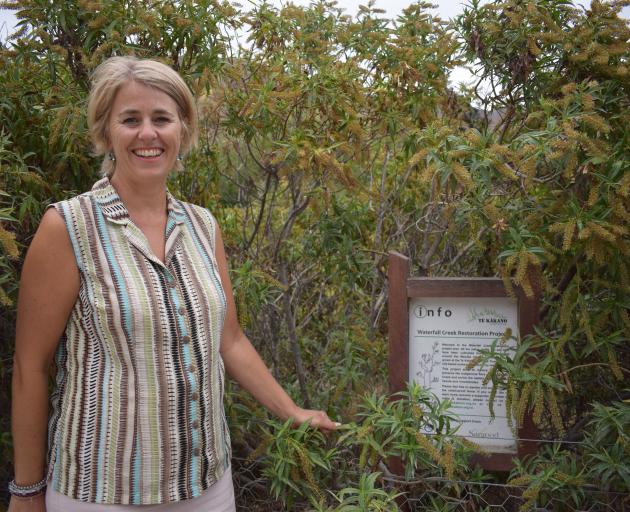 The Upper Clutha Water Group spokeswoman Megan Williams with shrubs planted eight years ago by Te...