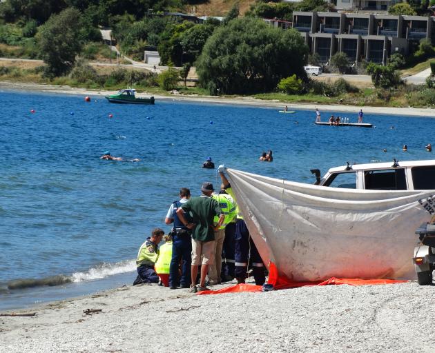 Emergency services treat a man at the Lake Wanaka waterfront this afternoon. PhotoL Sean Nugent