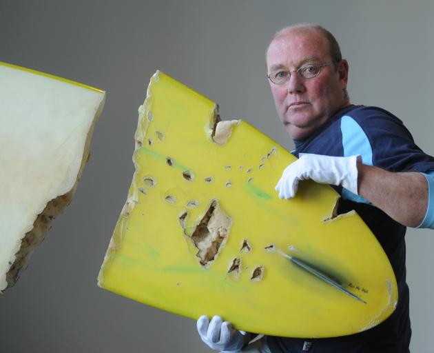 Shark attack survivor Barry Watkins, with his Surfboard from the attack which is donated to the Otago Museum. Photo: Peter McIntosh