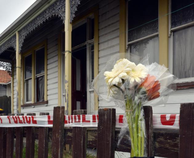 A bouquet of flowers is placed outside a Wesley St property after a fatal fire in Dunedin...