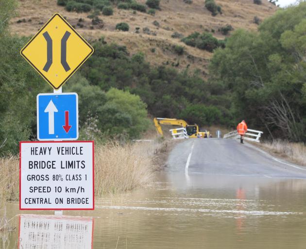 The road leading up to the bridge is flooded and has been closed to traffic. Photo: Nicole Sharp