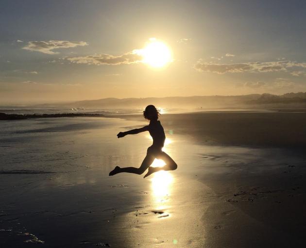 Isabel Martin (8), of Wanaka, jumps for joy in the summer sun at Brighton Beach. Photo: Briony Martin