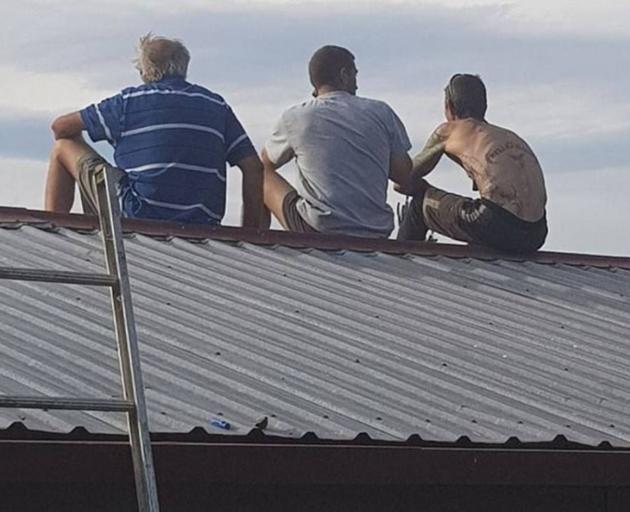 Emalee Millar took this photo of her father and his boss and workmate, as they watched the Burnside blaze yesterday afternoon. Photo / Facebook