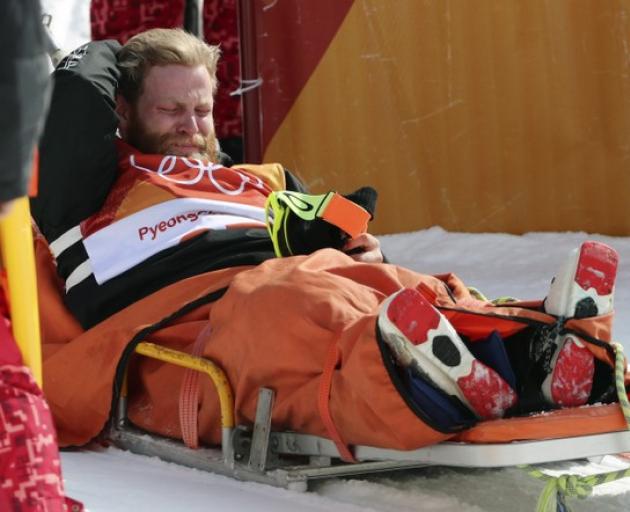 Byron Wells reacts after injuring himself before the men's ski halfpipe final at the Winter Olympics. Photo: Reuters 