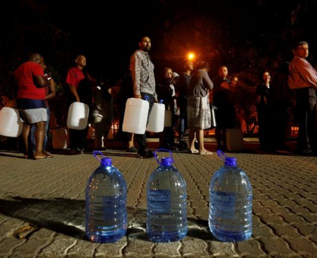 People queue to collect water as fears over the city's water crisis grow in Cape Town. Photo: Reuters