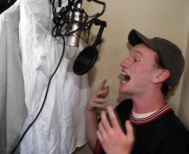 Christian Tucker performs one of his poems in his makeshift recording studio. Photo: Stephen Jaquiery