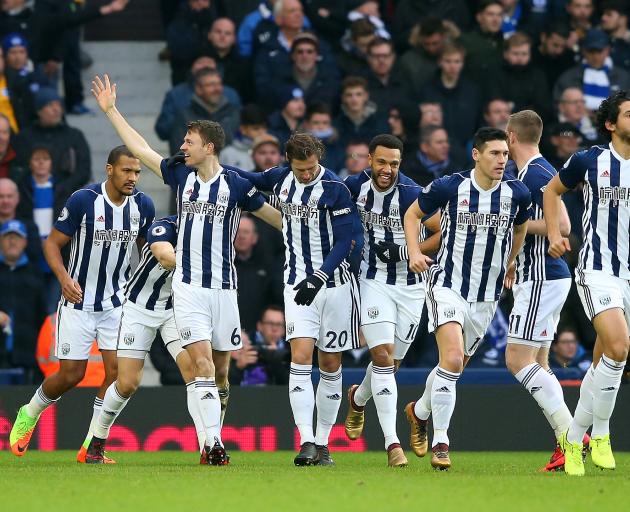 West Bromwich Albion players Jonny Evans (with raised arm) and Gareth Barry (second from right)...