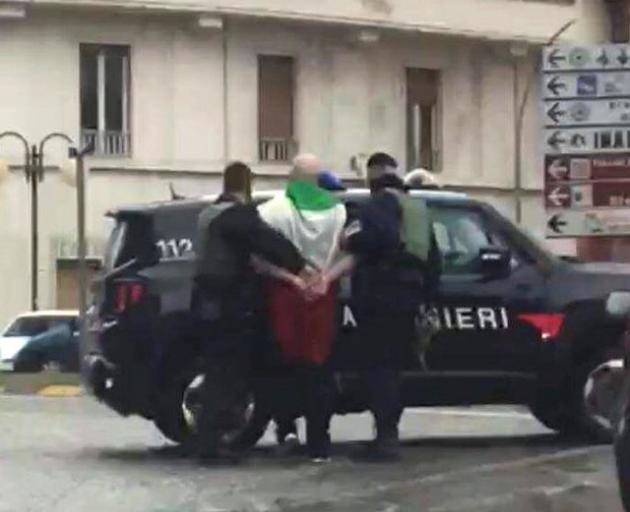 The suspected shooter that opened fire on African migrants, identified as Luca Traini, 28, is seen detained by Italian Carabinieri in Macerata. Photo: Italian Carabinieri/Handout via Reuters