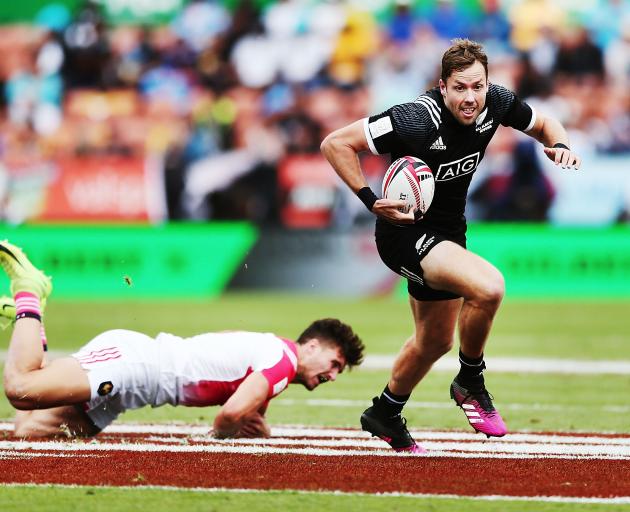 Tim Mikkelson of New Zealand beats a tackle against France during the 2018 New Zealand Sevens. Photo: Getty Images