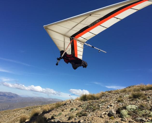 Julian Sands launches from ``Magic Mountain'' during the New Zealand Hang Gliding and Paragliding...