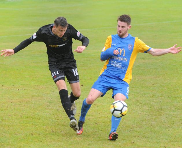 Team Wellington defender Angus Kilkolly (left) and Southern United forward Garbhan Coughlan fight...