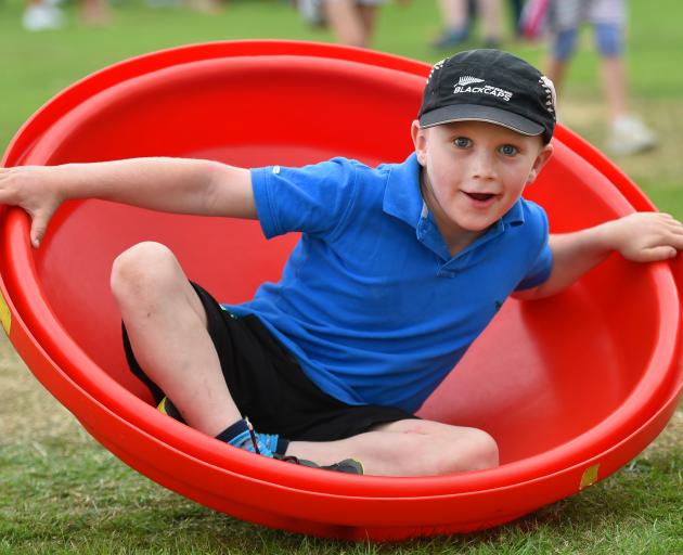 William Evans, (8), of Mosgiel, in a Dizzy Giddy at the Silverstream Primary School’s stand at...