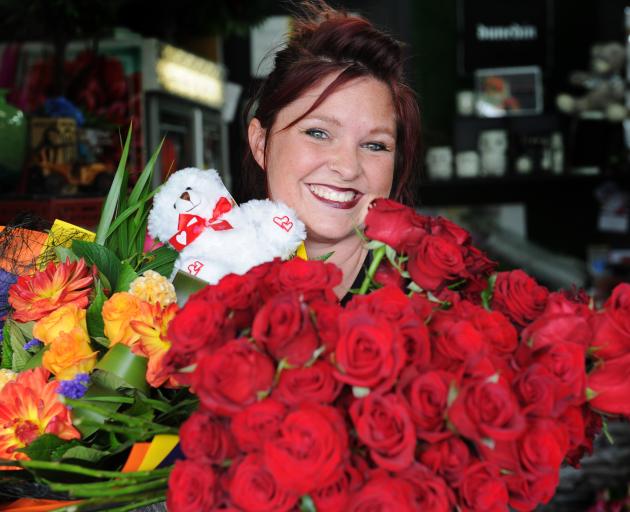 Dunedin florist Donna Hewer with red roses and a colourful bouquet for Valentine’s Day. Photo: Christine O'Connor