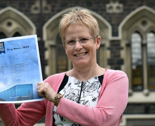 Prof Helen Nicholson holds a copy of the celebration schedule for the University of Otago's 150th...