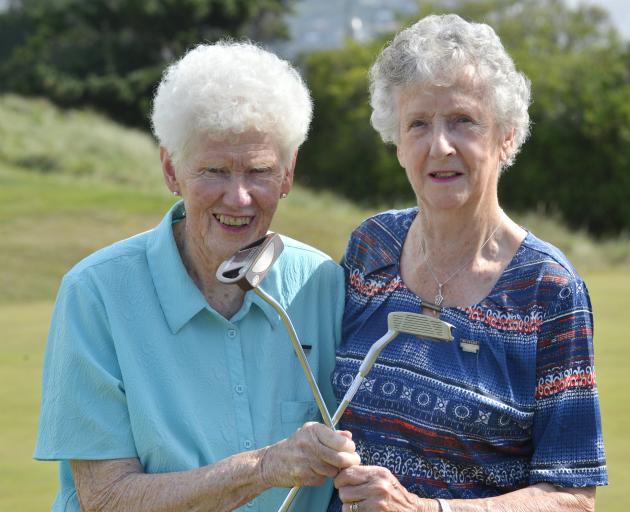 Dunedin women Reina Booth (left) and Audrey Duncan celebrate half a century of happy golfing at Chisholm Links on Tuesday. Photo: Gerard O'Brien