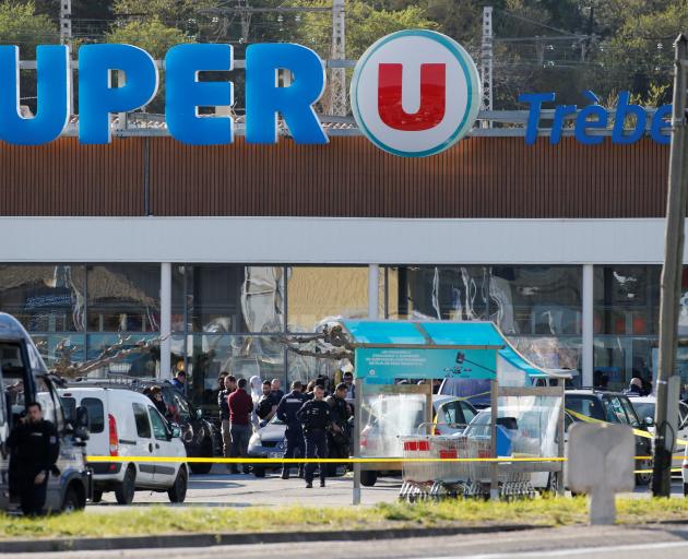 A general view shows gendarmes and police officers at a supermarket after a hostage situation in...