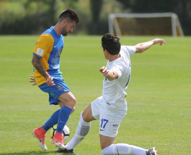 Southern United midfielder Alex Risdale (left) and Waikato's Xavier Pratt clash in the mach at...