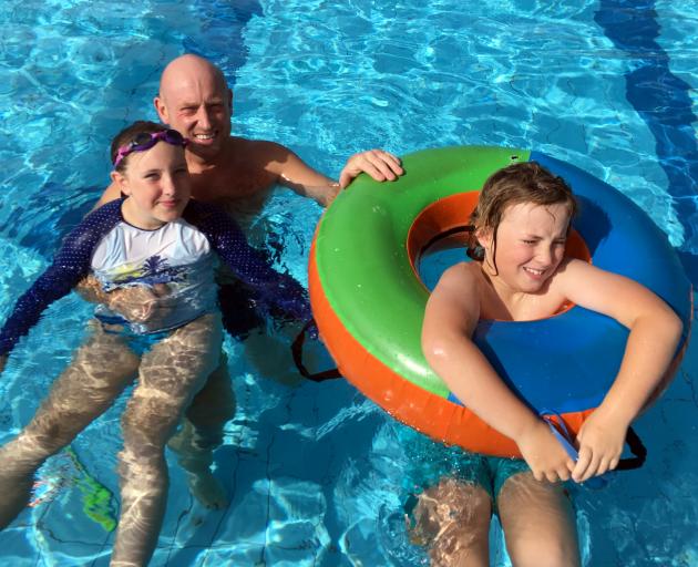 Steve Earp and his children, Iris and George, of Dunedin, enjoy the St Clair Hot Salt Water Pool...