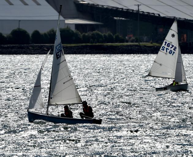 Competing in the South Island secondary schools sunburst championships at Otago Harbour yesterday were the Logan Park High School crew of Linus Molteno (left) and skipper Theo Molteno (foreground) while at the back is another Logan Park High School crew o