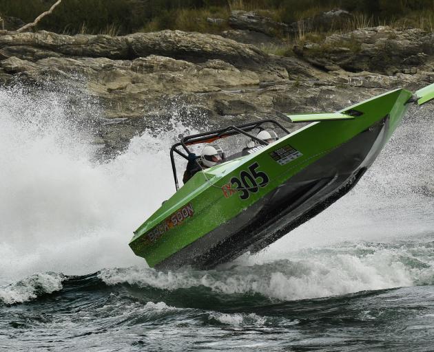 Steve Rapsey, of Christchurch, flies through the air while driving his boat along the Clutha...