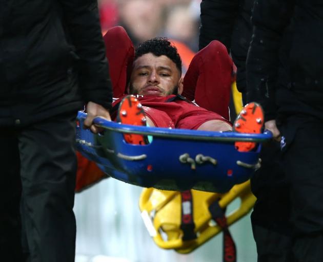 Liverpool's Alex Oxlade-Chamberlain is stretchered off the field in yesterday's Champions League...