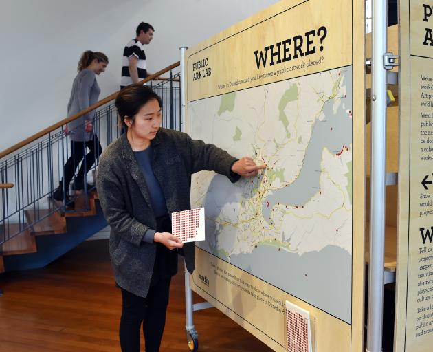 Dunedin Public Art Gallery customer liaison officer Dana Lee looks at a map on which the public...