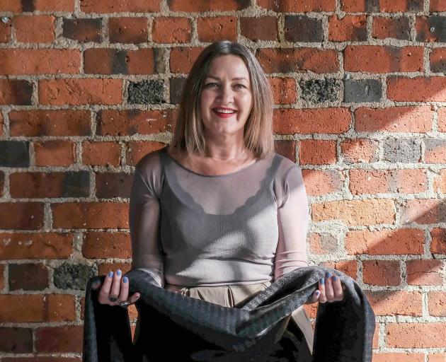 Bernadette Casey, creative director of The Formary, holding WoJo fabric made from recycled coffee...