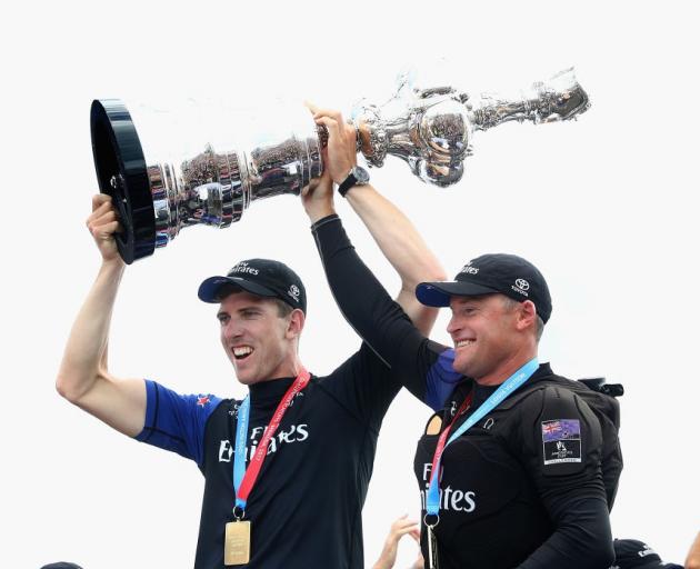 Glenn Ashby (right) lifts the America's Cup with Peter Burling. Photo: Getty Images