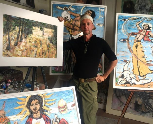 Artist Eion Shanks with some of his recent paintings. PHOTO: SUPPLIED

