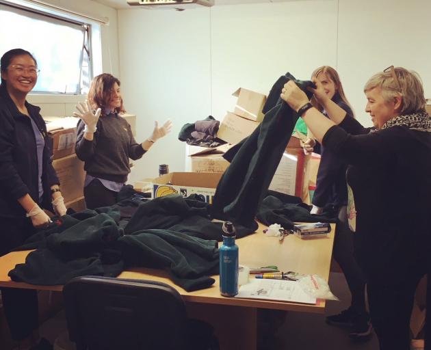 Wellington Zoo and the Formary staff sort the zoo's decommissioned uniforms for reprocessing as...