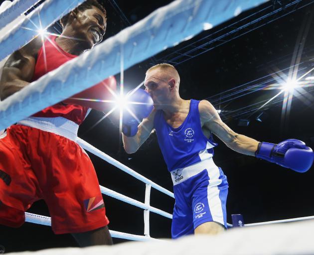 New Zealand's Richard Hadlow competes against Edrian Volcree of the Seychelle's during the Boxing...