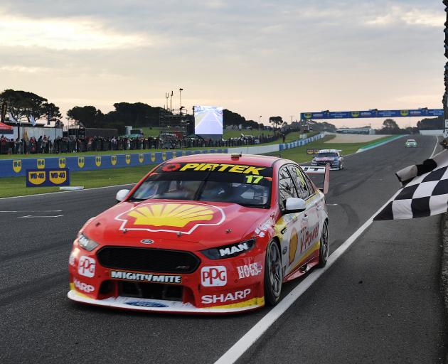 Scott McLaughlin takes the chequered flag during the Supercars Phillip Island 500. Photos: Getty...