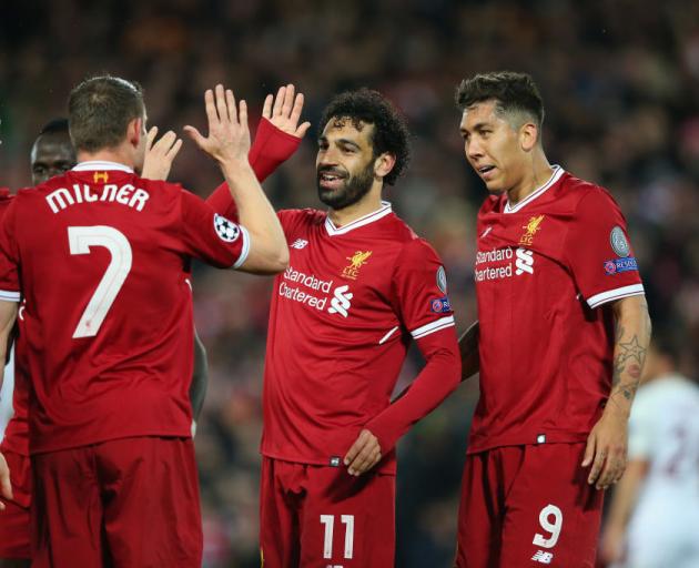Mohamed Salah celebrates a goal with team mates during Liverpool's 5-2 win in the first leg of...