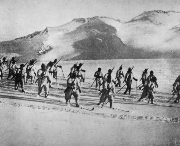 With the Italian Army: Alpine troops advancing over snow-covered ground in mountainous country. -...