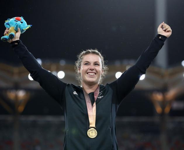 Julia Ratcliffe celebrates on the podium after receiving her gold medal. Photo: Getty Images