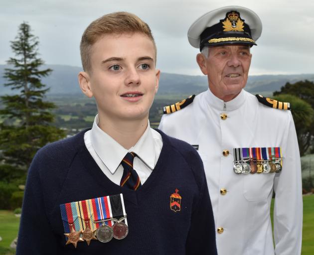 Nate Wisnesky (15), pictured with his great-uncle Commander Keith Wisnesky, wears medals...