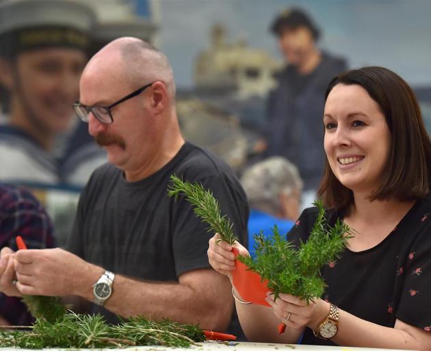  NZI staff Daryl Inch and Laura Paterson are among about 70 people creating posies of rosemary...