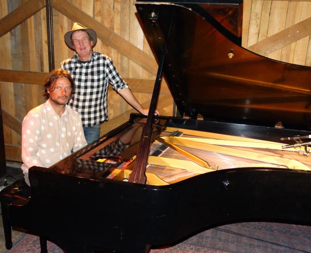 Pianist Jonathan Crayford sits at a 1955 Steinway D concert grand piano which he played in...