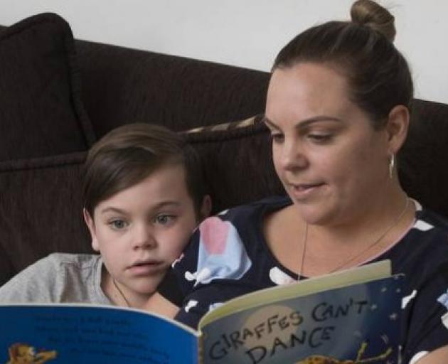 5-year-old Ante Fletcher reads a book with his mother Rebecca Fletcher at home. Photo: NZ Herald