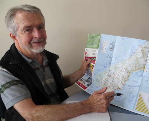 Author Tony Healy with his South Island map pinpointing unexplained sightings. Photo: Toni Williams