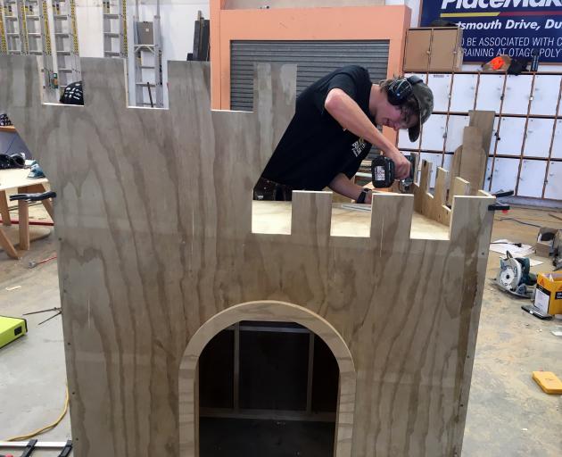 Gray Brothers Builders apprentice Sam Paris, of Shiel Hill, builds a children’s castle to win a regional heat in the annual New Zealand Certified Builders Apprentice Challenge in Dunedin on Saturday. Photo: Shawn McAvinue